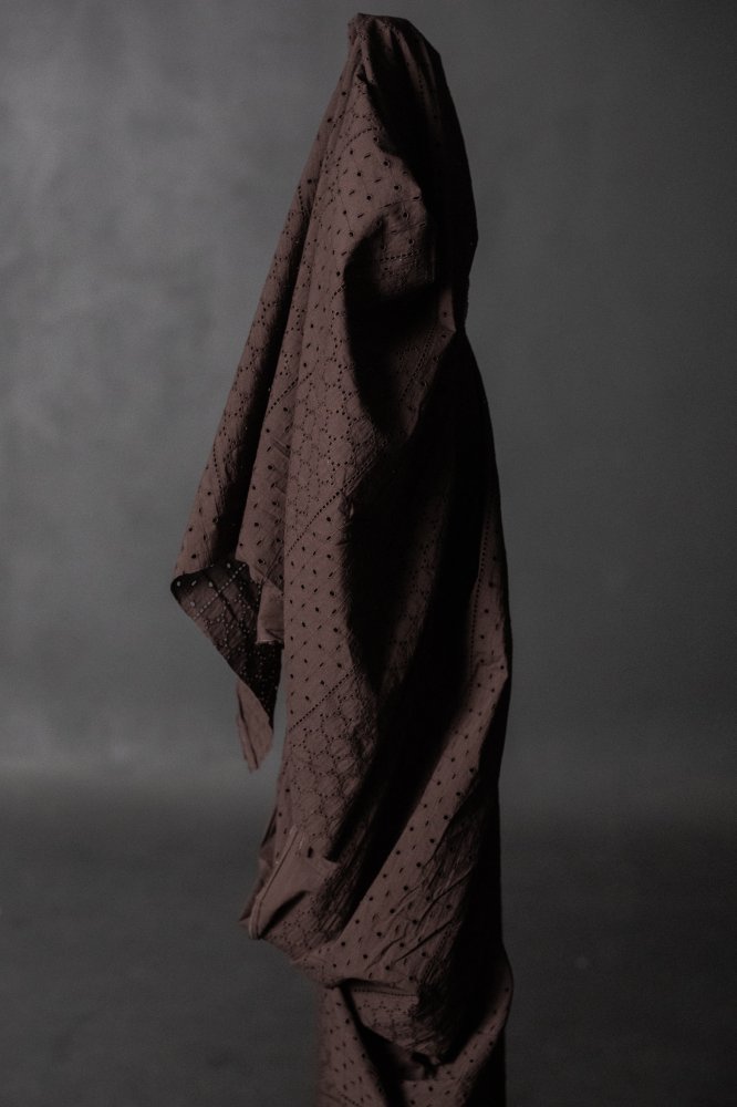 a dark rich purple eyelet embroidered cotton fabric