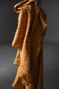 Bandhani tie-dye indian cotton fabric in bright ginger