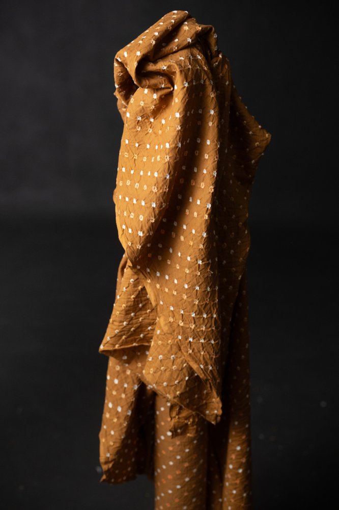 Bandhani tie-dye indian cotton fabric in bright ginger