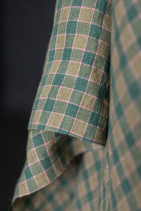 A green and pink laundered linen check fabric
