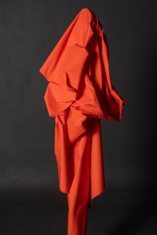 An orange red crisp cotton poplin fabric
