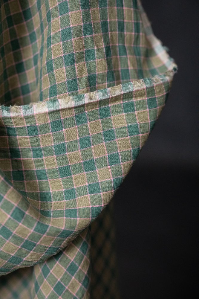 A green and pink laundered linen check fabric